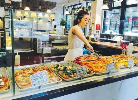  ?? — PHOTOS: MIA STAINSBY ?? There are 10 Roman-style pizzas to choose from at the front counter at Joe Pizza.