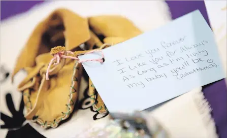  ?? JOHN WOODS
THE CANADIAN PRESS ?? A pair of baby moccasins at a press conference in Winnipeg in support of the mother whose newborn was seized by child and family services.