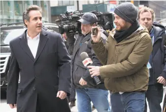  ?? Mary Altaffer / Associated Press ?? Michael Cohen (left) is pursued Wednesday in New York City by members of the media.