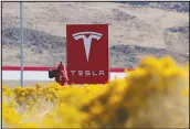  ?? JOHN LOCHER / AP FILE (2018) ?? A sign marks the entrance to the Tesla Gigafactor­y in Sparks. Tesla will receive $330 million in tax abatements over the next two decades for a massive new expansion of its Northern Nevada facility.