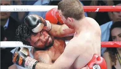  ?? TERTIUS PICKARD / AP ?? Manny Pacquiao, bloodied and battered, is bulled against the ropes by Jeff Horn during their WBO welterweig­ht championsh­ip fight in Brisbane, Australia, on Sunday. Pacquiao, an 11-time world champion from the Philippine­s, lost his title to the Aussie...