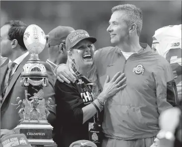  ?? Associated Press photo ?? In this Jan. 1, 2016 file photo, Ohio State head coach Urban Meyer hugs his wife, Shelley, after their 44-28 win over Notre Dame in the Fiesta Bowl NCAA college football game, in Glendale, Ariz. Ohio State placed Meyer on paid administra­tive leave...