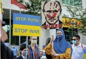  ?? /Annice Lyn/Getty Images ?? Villain: Ukrainian protesters hold up a poster of Russian President Vladimir Putin at a rally at the Russian Federation embassy in Kuala Lumpur, Malaysia, on February 28 2022.