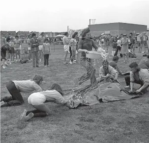  ??  ?? Competitor­s at the It’s A Knockout competitio­n at Furze Platt School’s summer fete in 1975. Ref:132818-4
