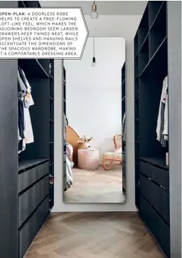  ??  ?? OPEN-PLAN: A DOORLESS ROBE HELPS TO CREATE A FREE-FLOWING LOFT-LIKE FEEL, WHICH MAKES THE ADJOINING BEDROOM SEEM LARGER. DRAWERS KEEP THINGS NEAT, WHILE OPEN SHELVES AND HANGING RAILS ACCENTUATE THE DIMENSIONS OF THE SPACIOUS WARDROBE, MAKING IT A COMFORTABL­E DRESSING AREA.