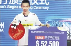  ??  ?? FUZHOU: Lee Chong Wei of Malaysia poses with his trophy after the men’s singles final match against Chen Long of China at the China Open badminton tournament in Fuzhou, east China’s Fujian province yesterday. — AFP