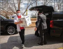  ?? STEVE SCHAEFER/FOR THE AJC ?? Walgreens employee Taylor Truelove rushes a new supply of the Pfizer vaccine into St. Philip AME Church in Atlanta for the inoculatio­n event this month.