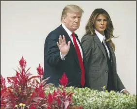  ?? CAROLYN KASTER / AP ?? President Donald Trump walks along the colonnade with first lady Melania Trump Oct. 11 at the White House. A year after the 2016 election, Trump’s presidency has succeeded in energizing both Republican­s and Democrats.