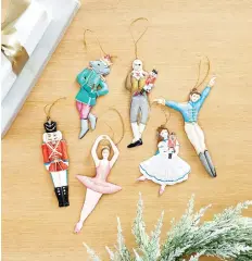  ??  ?? Ballard Designs’ Nutcracker collection includes handmade, hand-painted ornaments based on the iconic holiday ballet.