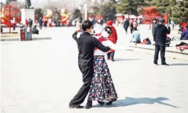  ?? Photo: AFP via Getty Images ?? A couple dance at a park in Shenyang, China as the country reported no new local cases of coronaviru­s and life is slowly returning to normal after a two-month lockdown
