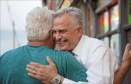  ?? Jessie Wardarski/Post-Gazette ?? Allegheny County District Attorney Stephen A. Zappala Jr. hugs longtime friend Paul Roell, of the South Side Slopes, as Mr. Zappala arrives at his primary election victory party Tuesday at Cupka’s Cafe II on the South Side.