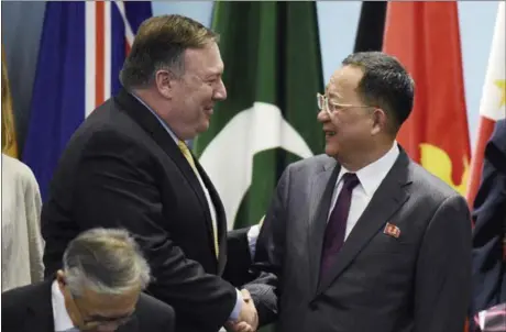  ?? JOSEPH NAIR — THE ASSOCIATED PRESS ?? Secretary of State Mike Pompeo, left, greets North Korea’s Foreign Minister Ri Yong-ho as they prepare Saturday for a group photo at the 25th ASEAN Regional Forum Retreat in Singapore. Pompeo stated that North Korea is far from living up to its...