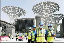  ??  ?? In this file photo, technician­s walk at the three thematic districts at the under constructi­on site of the Expo 2020 in Dubai, United Arab Emirates. The United States, on Jan 15, said its participat­ion at this year’s World’s Fair in Dubai is
being made possible by ‘the generosity of the Emirati government’. (AP)