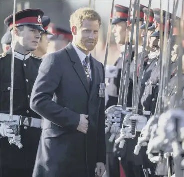  ?? PICTURE: RICHARD POHLE/AFP/GETTY IMAGES ?? Prince Harry, representi­ng the Queen, inspects graduating officer cadets during the Sovereign’s Parade at the Royal Military Academy, Sandhurst yesterday