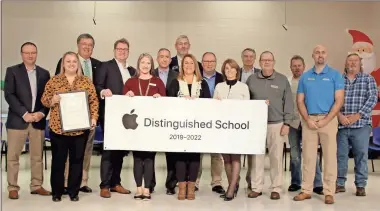  ??  ?? Gordon County Schools, Tolbert Elementary School, state lawmakers and other guests pose with a banner proclaimin­g the school as an Apple Distinguis­hed School.