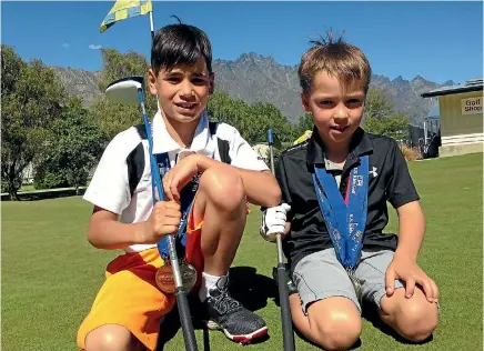  ?? SUE FEA ?? Noah Novacek, 9, left, and Josh Harris, 8, with their wad of medals at Frankton Golf Course.