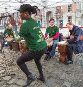  ??  ?? An Taoiseach Enda Kenny plays the bongos with the Afro-Eire group at the launch of RTÉ’s Cruinniú na Cásca at Dublin Castle last night.