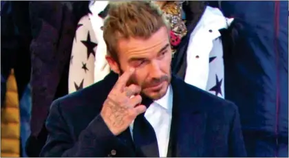  ?? ?? EMOTIONAL: David Beckham wipes away a tear on Friday while paying his respects to the Queen at Westminste­r Hall