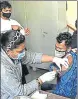  ?? VIPIN KUMAR/HT PHOTO ?? A health worker administer­s Covid vaccine.