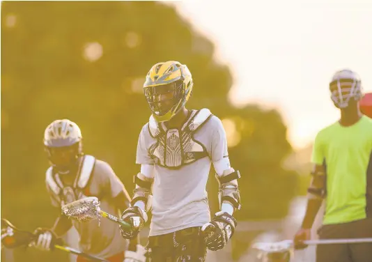  ?? FILE ?? Nathanel Moulton (centre) and other members of Jamaica College’s lacrosse team go through a training session at the Jamaica College Ashenheim Stadium on January 16, 2020.