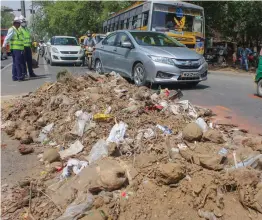  ?? — PTI ?? A pile of garbage lies in the middle of a road in Gurgaon on Monday as municipal corporatio­n workers are on strike for the past two days.