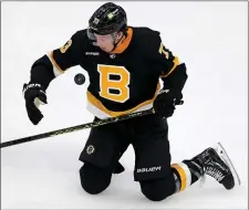  ?? MATT STONE — BOSTON HERALD ?? BOSTON, MA - February 20: Charlie McAvoy #73 of the Boston Bruins tries to grab a loose puck during the second period of the Ottawa Senators at the TD Garden on February 20, 2023 in Boston, Massachuse­tts