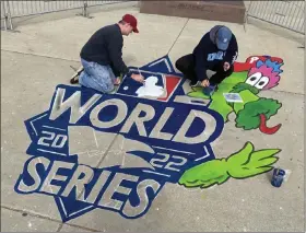  ?? PETE BANNAN-DAILY TIMES ?? Mike and Judi Macaulay pains the World Series logo and Philly Fanatic in front of Citizens Bank Park Monday. They started at 6a.m. and expected to be finished by 4p.m.