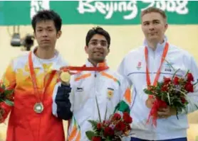  ??  ?? Abhinav Bindra (centre) with his gold medal.