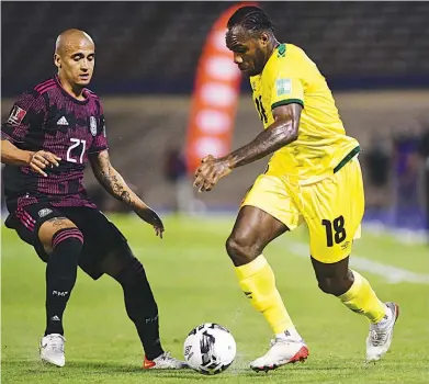  ?? GLADSTONE TAYLOR ?? Jamaica’s Michail Antonio (right) in action against Mexico’s Luis Rodriguez during their Concacaf World Cup qualifier at the National Stadium on Thursday, January 27. Mexico won 2-1.