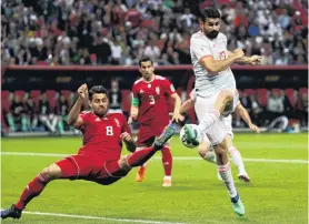  ?? PHOTO: REUTERS ?? Full stretch . . . Spain’s Diego Costa shoots at goal as Iran’s Morteza Pouraligan­ji tries to stop him.