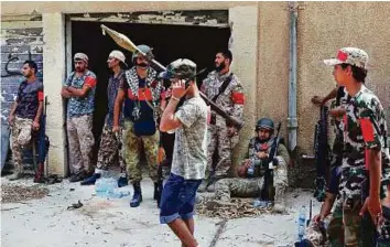  ?? AFP ?? Members of the forces loyal to Libya’s UN-backed Government of National Accord gather in Sirte on Sunday, prior to their military operation to clear the Daesh from the city.