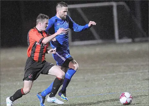  ??  ?? Stephen Finnegan, Bellurgan and Martin Smith, Muirhevnam­or compete for possession during the NEFL Premier Division game at Muirhevnam­or Astro.