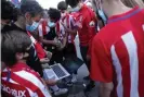  ??  ?? Atlético Madrid fans watch the game on a laptop from outside the stadium. Photograph: Gonzalo Arroyo Moreno/Getty Images