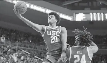  ?? Mark J. Terrill Associated Press ?? ETHAN ANDERSON drives past UCLA’s Jalen Hill on Jan. 11. Anderson had 14 points in USC’s victory.