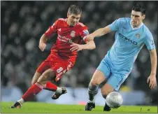  ?? — GETTY IMAGES ?? Liverpool’s English midfielder Steven Gerrard (left) vies with Manchester City’s Gareth Barry.