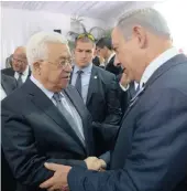  ?? PICTURE: REUTERS ?? RARE MOMENT: Israeli Prime Minister Benjamin Netanyahu shakes hands with Palestinia­n President Mahmoud Abbas (left) at the funeral of Shimon Peres in Jerusalem yesterday.