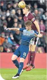  ??  ?? Hearts captain Christophe Berra gets above David Templeton to clear