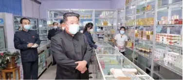  ?? Agence France-presse ?? ↑
A photo, released by KCNA on Monday, shows Kim Jong Un (centre) inspect a pharmacy in Pyongyang.