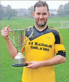  ??  ?? Inveraray captain John Mackenzie with the 2018 Mòd Shinty Cup.