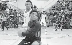  ?? KARL MERTON FERRON/BALTIMORE SUN ?? Poly guard Demetrius Mims tries to stop Dunbar guard-forward Shaun Tolbert from finding a passing lane during Saturday’s Baltimore City Division I championsh­ip.