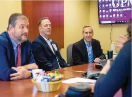  ?? UPMC CREATIVE SERVICES ?? John Krolicki, center, chief administra­tive sustainabi­lity officer, and Dr. Mike Boninger, right, chief medical sustainabi­lity officer, meet with the UPMC Center For Sustainabi­lity
Steering Committee.