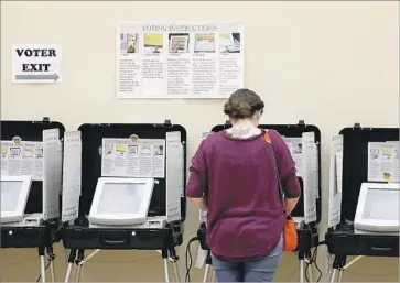  ?? Joe Raedle Getty Images ?? A VOTER in Sandy Springs, Ga., in June. A Santa Monica cybersecur­ity researcher said he found glaring weaknesses in Georgia’s elections system this year. “There were so many things wrong,” he said.