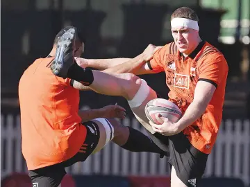  ?? — AFP photo ?? New Zealand All Blacks' Brodie Retallick (R) and Jerome Kaino take part in a stretching exercise during a training session in Sydney on August 17, 2017, ahead of the first Rugby Championsh­ip and Bledisoe Cup Test match against Australia.