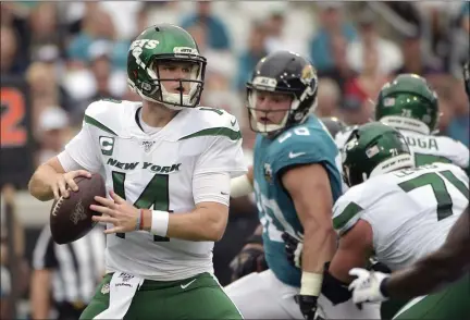  ?? PHELAN M. EBENHACK - THE ASSOCIATED PRESS ?? New York Jets quarterbac­k Sam Darnold, left, looks for a receiver as he is pressured by Jacksonvil­le Jaguars defensive tackle Taven Bryan, center, during the first half of an NFL football game, Sunday, Oct. 27, 2019, in Jacksonvil­le, Fla.