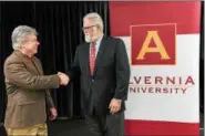  ?? PHOTO COURTESY MATTHEW WRIGHT ?? Alvernia University has joined Montgomery County Community College’s University Center and will offer two advanced degrees at the college’s west campus in Pottstown — a Master of Business and a Master in Education. Shown here during a ceremony at MCCC June 5 are MCCC President Kevin Pollock, left, and Alvernia’s Provost Jerry Greiner.