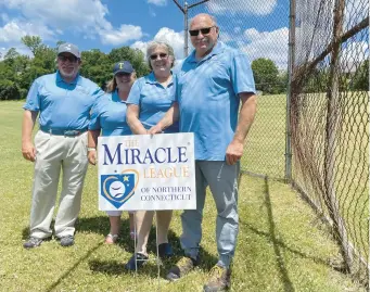  ?? HARTFORD COURANT ?? Steve Leibowitz, president of the Miracle League of Northern Connecticu­t and his wife Laurel , and Lisa and Roy Daniel, who help the Leibowitzs coach adaptive baseball in Tolland, at the site of what will be a new Miracle League sports field at the Northeast School in Vernon.