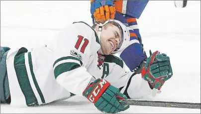  ?? CP PHOTO ?? Minnesota Wild left wing Zach Parise (11) is roughed up by an Edmonton Oiler during NHL action in Edmonton, Alta. on Jan. 31.