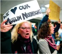  ?? AFP ?? SHOW OF SUPPORT: Protesters gather at the arrivals area of the Washington Dulles Internatio­nal Airport in Sterling, Virginia. —