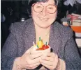  ??  ?? Janell Landis holds tops that she carved while apprentici­ng with Michiaki Hiroi.