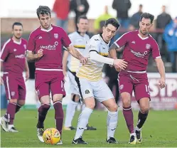  ?? Pictures: SNS Group. ?? Bobby Linn, top, right, heads in to level for Arbroath; Danny Denholm and Gavin Swankie, above, combine to thwart Dumbarton’s Stuart Carswell.